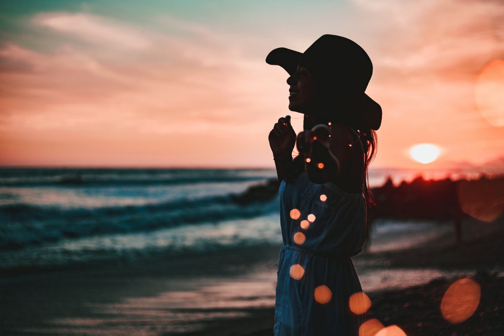 Woman on beach at sunset